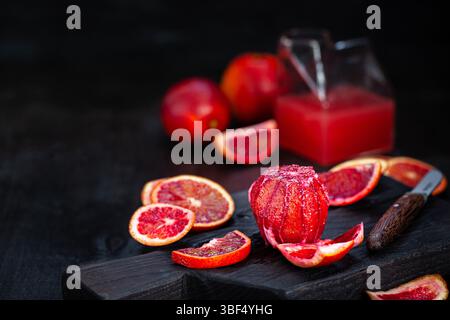 Fresh ripe red blood oranges (sicilian) on dark background Stock Photo