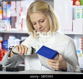 Pharmacist scanning medicine with barcode reader Stock Photo