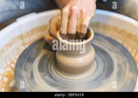 Pottering - creating a clay cup in process. Shot with a small GRIP Stock Photo