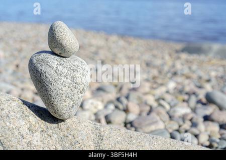 Stacked Rocks balancing, stacking with precision. Stone tower on the shore. Copy space Stock Photo