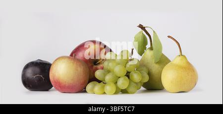 Plums, apples, pears, grapes on a white background, a copy of the space, a banner Stock Photo