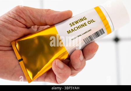 Sewing machine oil. Low-viscosity oil used in sewing machines to reduce friction and prevent wear on moving parts. Stock Photo