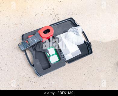 Earth clamp tester on case box ready to test ground. Stock Photo