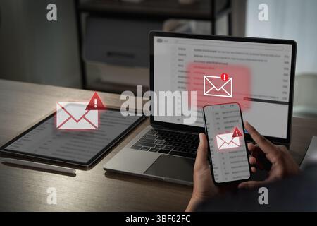 A mail alert, email hack sms spam image shows person checking email alerts multiple devices, indicating potential security or spam issues Stock Photo