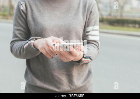 Asian woman using cellphone in the outdoor Stock Photo