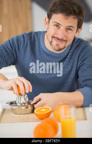 closeup on man making orange juice Stock Photo