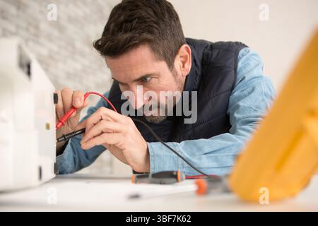 engineer using a voltage and current tester Stock Photo