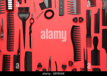 Frame of different hairdresser's tools on red background, flat lay. Space for text Stock Photo