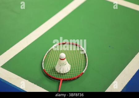 Badminton Sport Equipments, Shuttlecocks and Rackets, on PV Floor of Indoor Badminton Court, Soft Focus, Concept for Endurance Sports and Recreational Stock Photo