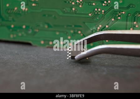 Working with semiconductor materials. Modern electronics and technology. Focused on 8-pin integrated circuit. Stock Photo