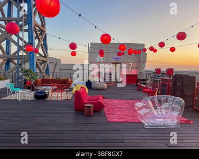 Los Angeles, California, USA - September 19, 2023  - Rooftop party setup with modern outdoor furniture, including sofas, chairs, and tables Stock Photo
