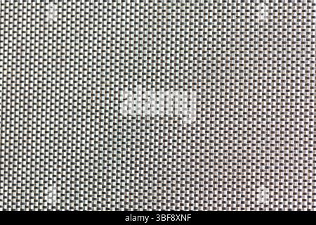 Close-up of woven fabric. The weave alternates between white and dark threads. Stock Photo
