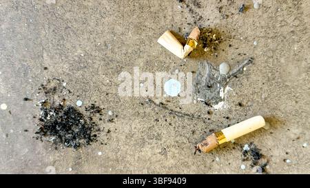 Cigarette Butts And Ashes On Dirty Pavement In Urban Environment Stock Photo