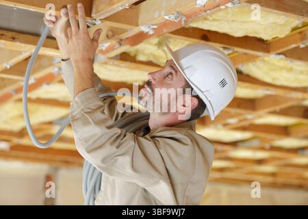 male builder working with cables Stock Photo
