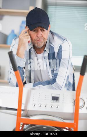 thoughtful washing machine technician Stock Photo