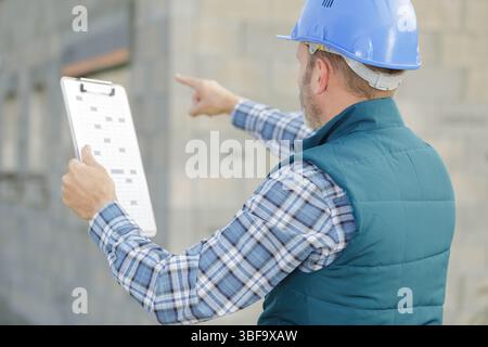 site manager pointing on place of future building Stock Photo