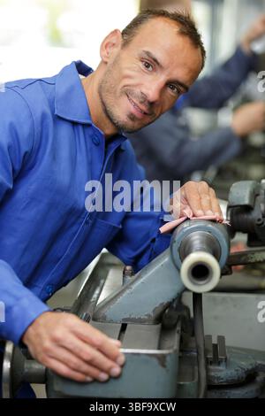 portrait of man using a belt sander Stock Photo