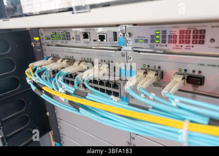 This image showcases the intricate setup of fiber optic cables in a high-tech data center, emphasizing modern technology for reliable data transmissio Stock Photo