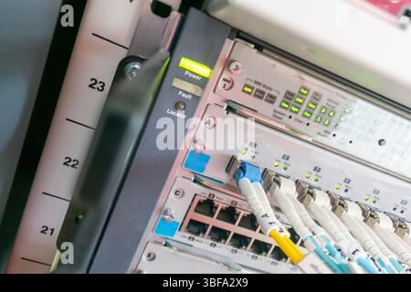 Close-up view of a modern server rack showcasing network cables, light indicators, and organizing panels. Ideal for technology and data infrastructure Stock Photo