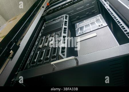 A modern server rack displaying various high-tech equipment and components, illustrating a professional data center setup designed for optimal perform Stock Photo