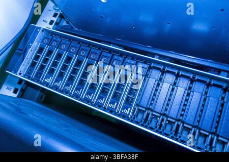 A blue-lit data storage server showcases advanced technology in a modern IT environment. The intricate design highlights components essential for data Stock Photo