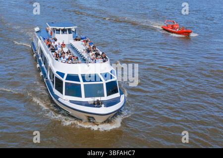 A River Thames cruise boat and Thames Rockets inflatable rib carry passengers on the river. Stock Photo