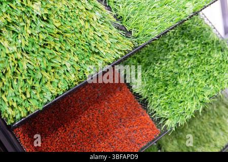 Samples of artificial lawn on the showcase. Industry Stock Photo