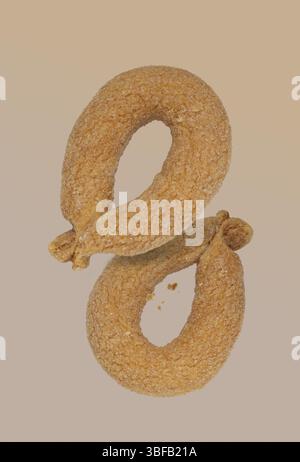 Two pretzels on a beige background, flying food Stock Photo