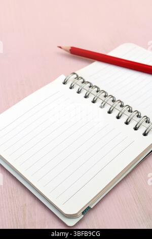 Red pencil and notebook for notes Stock Photo