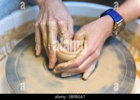 Pottering - creating a clay cup in process. Shot with a small GRIP Stock Photo