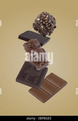 Chocolate candies flying on a yellow background Stock Photo