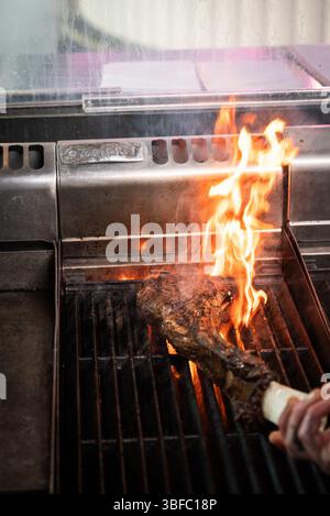 Tomahawk steak on fire in restaurant Stock Photo