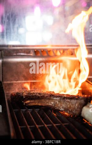 Tomahawk steak on fire in restaurant Stock Photo