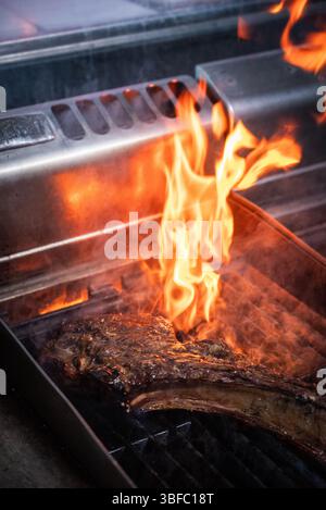 Tomahawk steak on fire in restaurant Stock Photo