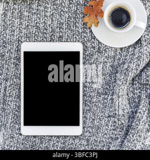 Creative square autumn flat lay overhead top view stylish home workspace with tablet notebook coffee cup cozy gray knitted plaid background copy space Stock Photo