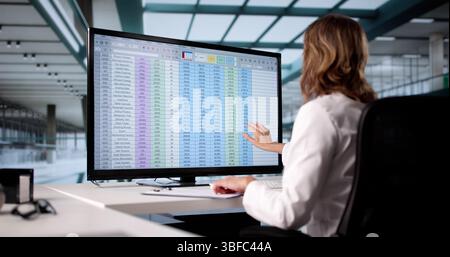 Woman Using Medical Coding Bill And Billing Codes Spreadsheets In Office Stock Photo