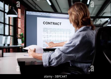 Analyzing Business Documents: Woman Insuring Agreement Paperwork On Online System Stock Photo