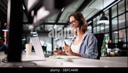 Smiling Call Center Representative Offers Exceptional Customer Care Via Phone. Stock Photo