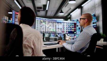Business Professionals Collaborating On Project Agenda Using Computer In Office. Man And Woman Managing Calendar Stock Photo