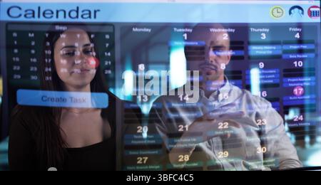 Tech-savvy Businessman Schedules Appointments On Transparent Calendar Using Hologram Overlay. Stock Photo