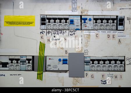 Old circuit board, electrical power distribution building, mains supply, electrician trade warning hazard safety Stock Photo
