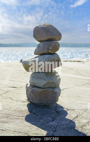 Stacked Rocks balancing, stacking with precision. Stone tower on the shore. Copy space Stock Photo
