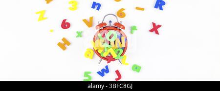 Creative flat lay back to school education concept with alarm clock and multicolor letters isolated on white background with copy space, template for Stock Photo