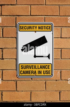 Security Notice - Surveillance Camera In Use sign attached to a brick wall Stock Photo
