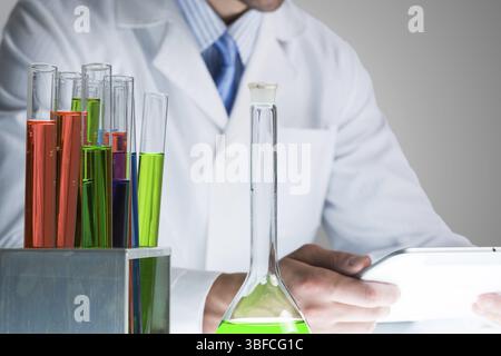 Close up of scientist hands working with tablet pc in laboratory Stock Photo