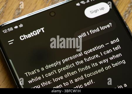 A message to ChatGPT asking "Will I find love", with the response on a smartphone screen. Concept: romance, philosophy, chatbot, large language models Stock Photo