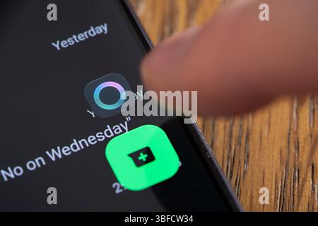 The new Meta Artificial Intelligence (AI) circle icon cannot be deleted from WhatsApp or disabled. Here a finger selecting it on a smartphone Stock Photo