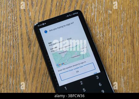 Android smartphone with the Microsoft Authenticator app showing a number to input on a work computer as part of two factor authentication (2FA or TFA) Stock Photo