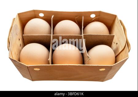 half a dozen country brown chicken eggs in plywood box cutout on white background Stock Photo