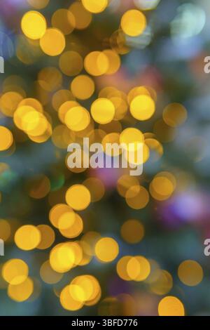 Chaotically placed bokeh circles shine with festive lights. Festive Christmas background Stock Photo